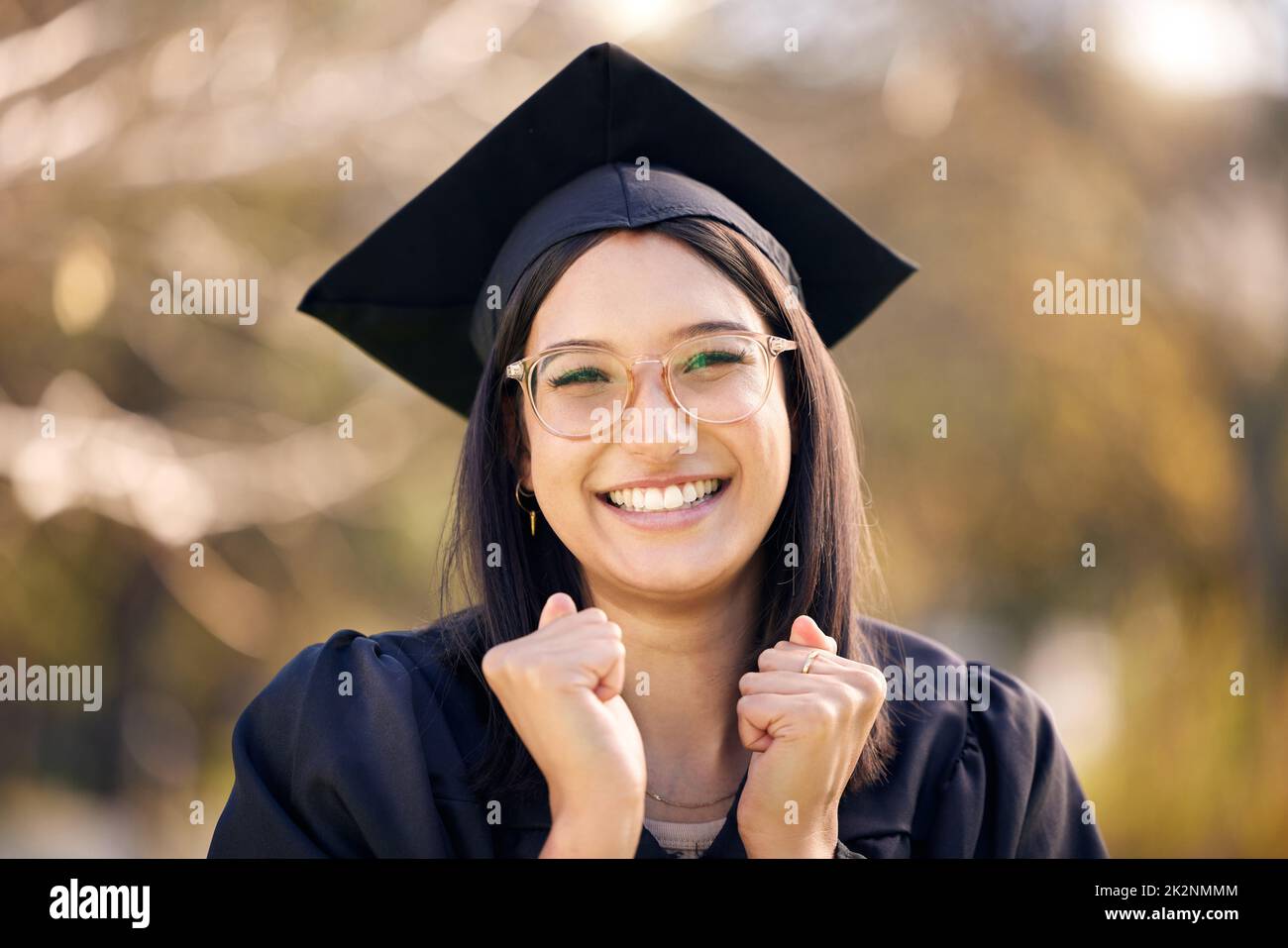 I cant believe this day is finally here. Shot of a young woman cheering on graduation day. Stock Photo