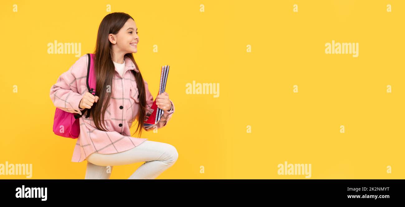 happy teen girl wear pink checkered shirt running with school bag and notebooks, runner. Banner