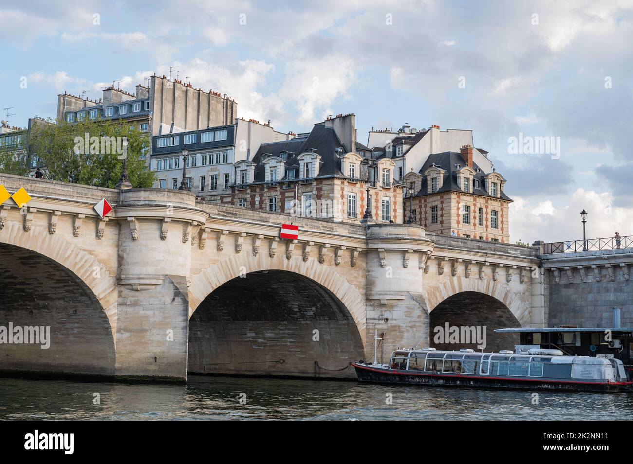 Famous Pont Neuf is the oldest standing bridge across river Seine in Paris, France with grotesk heads representing forest and field divinities from ancient mythology. Stock Photo