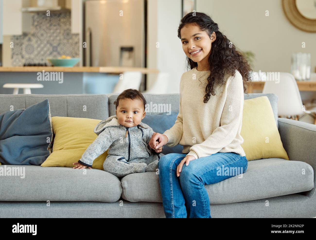 Hes the sweetest little boy. Shot of a young mother bonding with her baby boy on the sofa at home. Stock Photo