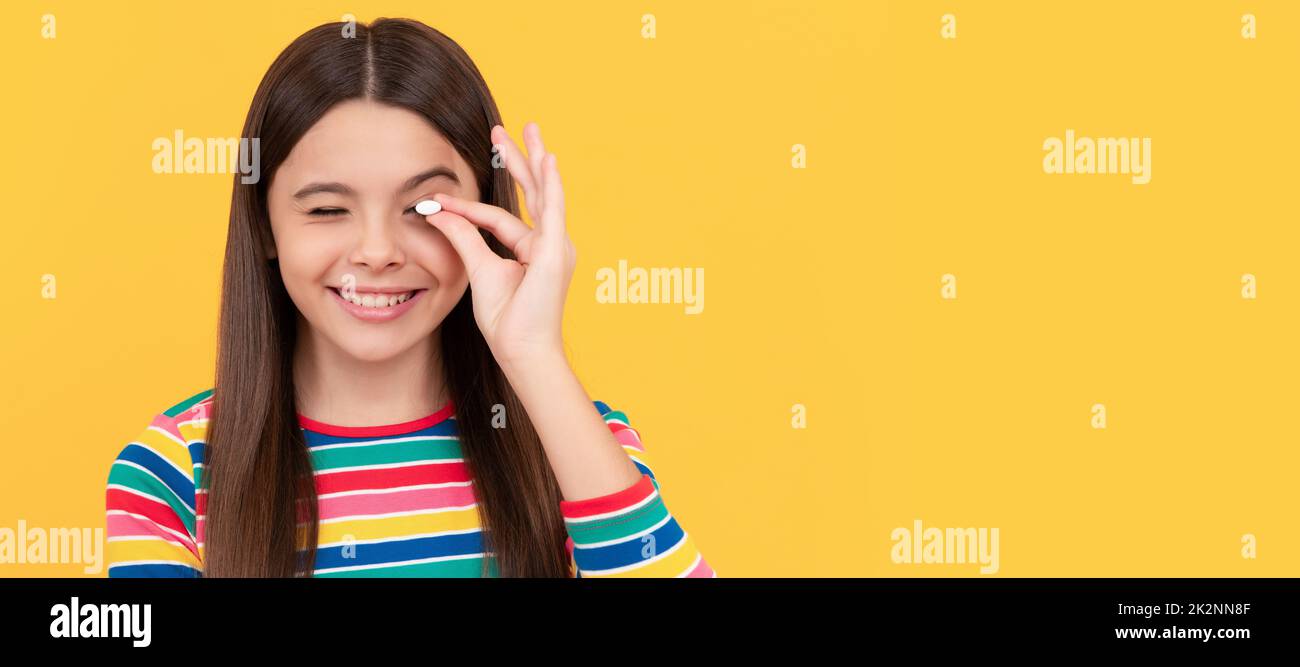 childhood health. food supplement. girl with natural pill products