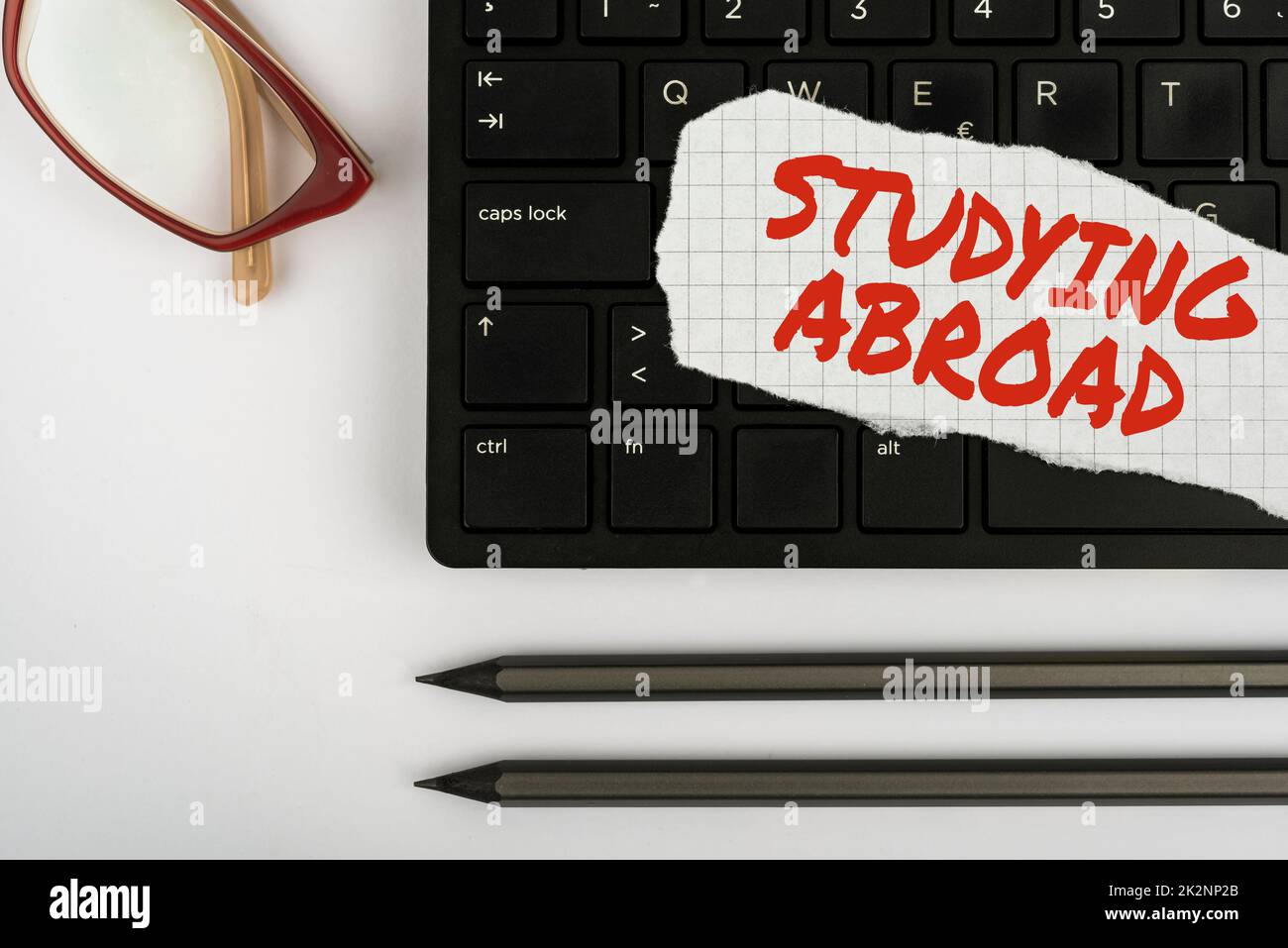 Text caption presenting Studying Abroad. Internet Concept learn outside of home in foreign country Travelling Computer Keyboard And Symbol.Information Medium For Communication. Stock Photo