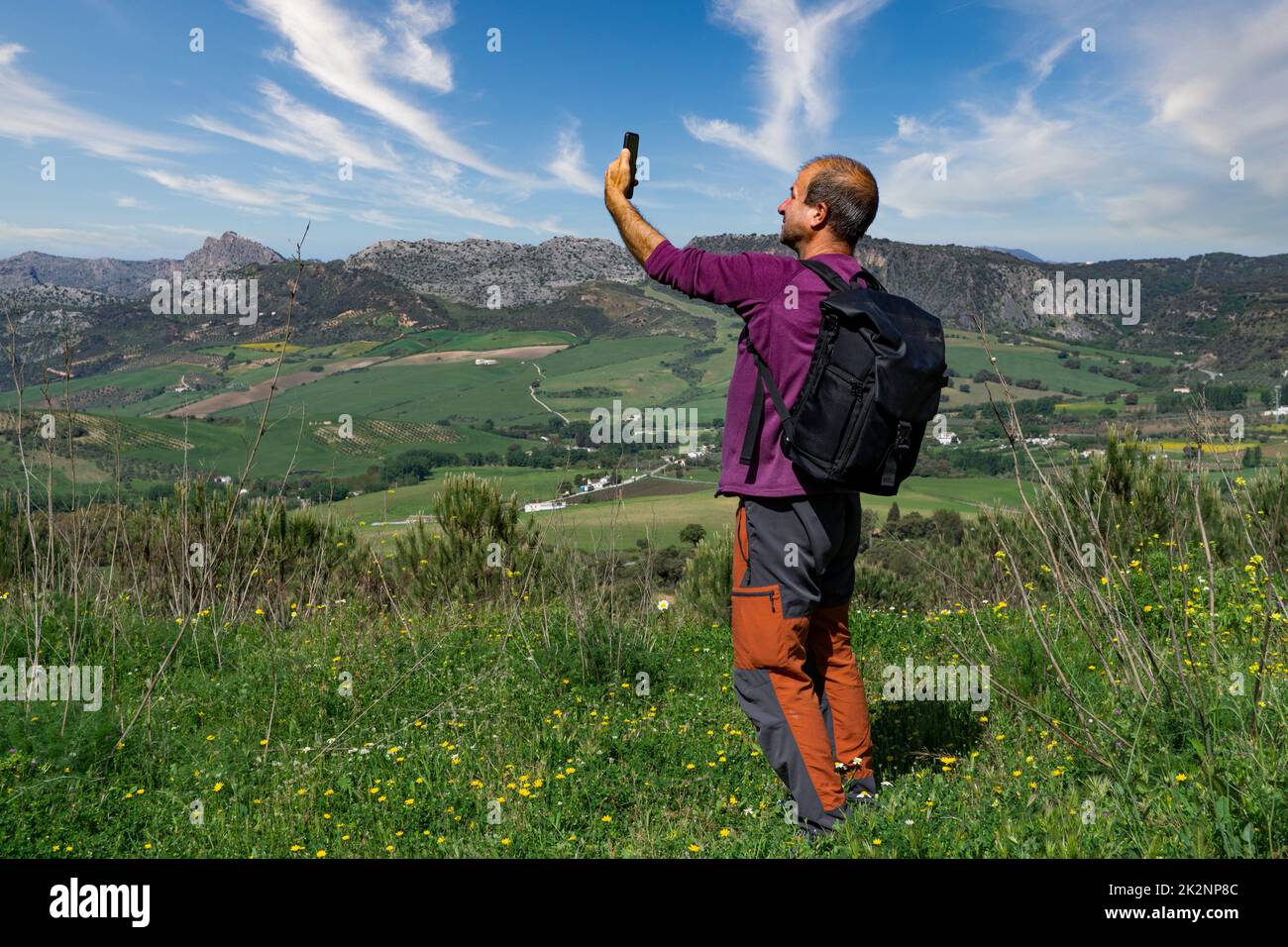 man looking for cell phone coverage in the mountains Stock Photo