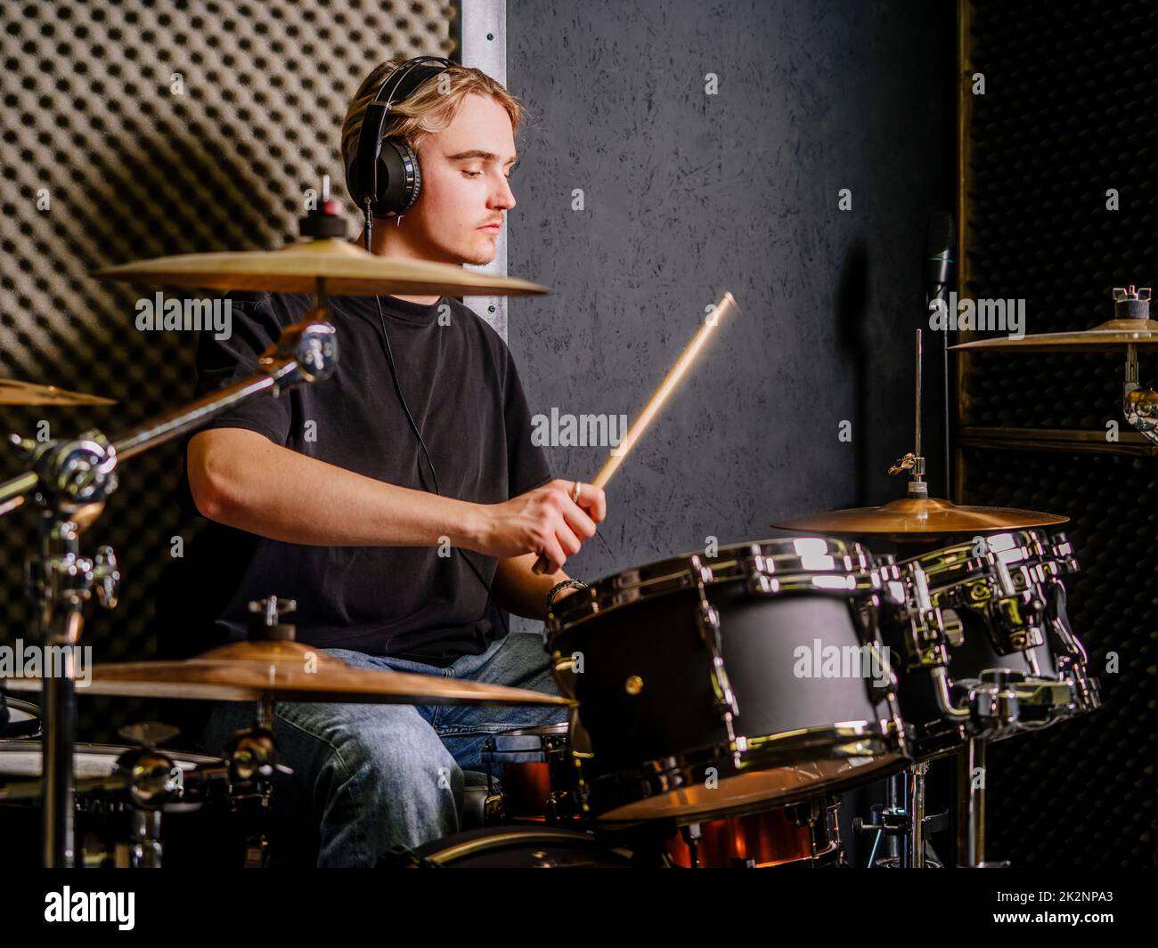 Young man playing drums in a recording studio Stock Photo