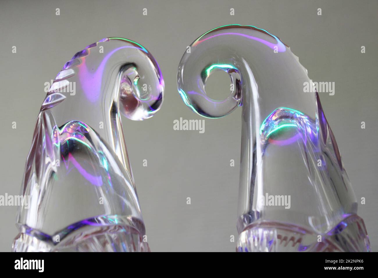 Crystal figures on a gray background in neon light. Stock Photo