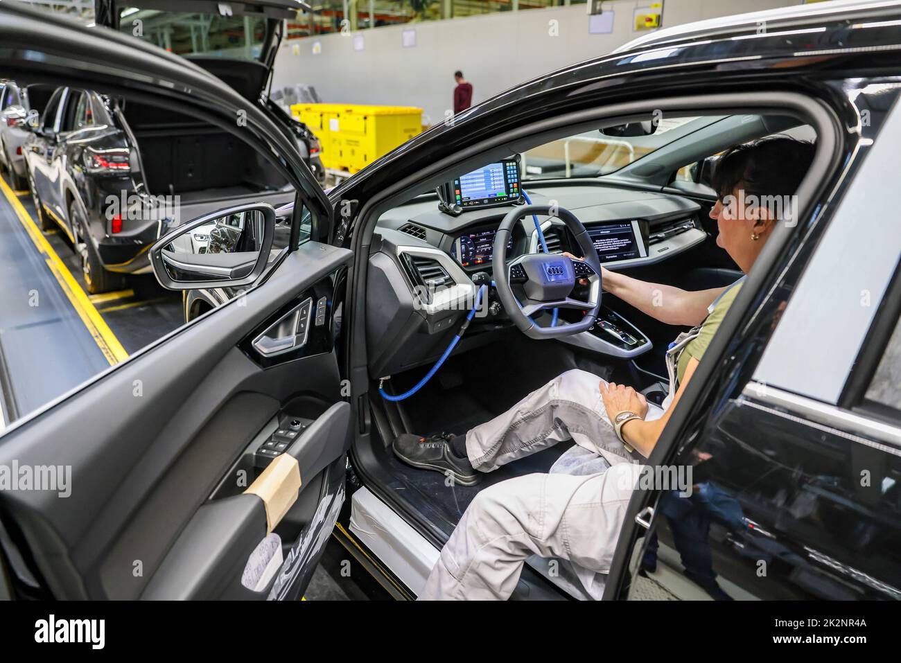26 April 2022, Saxony, Zwickau An employee tests all functions on a VW