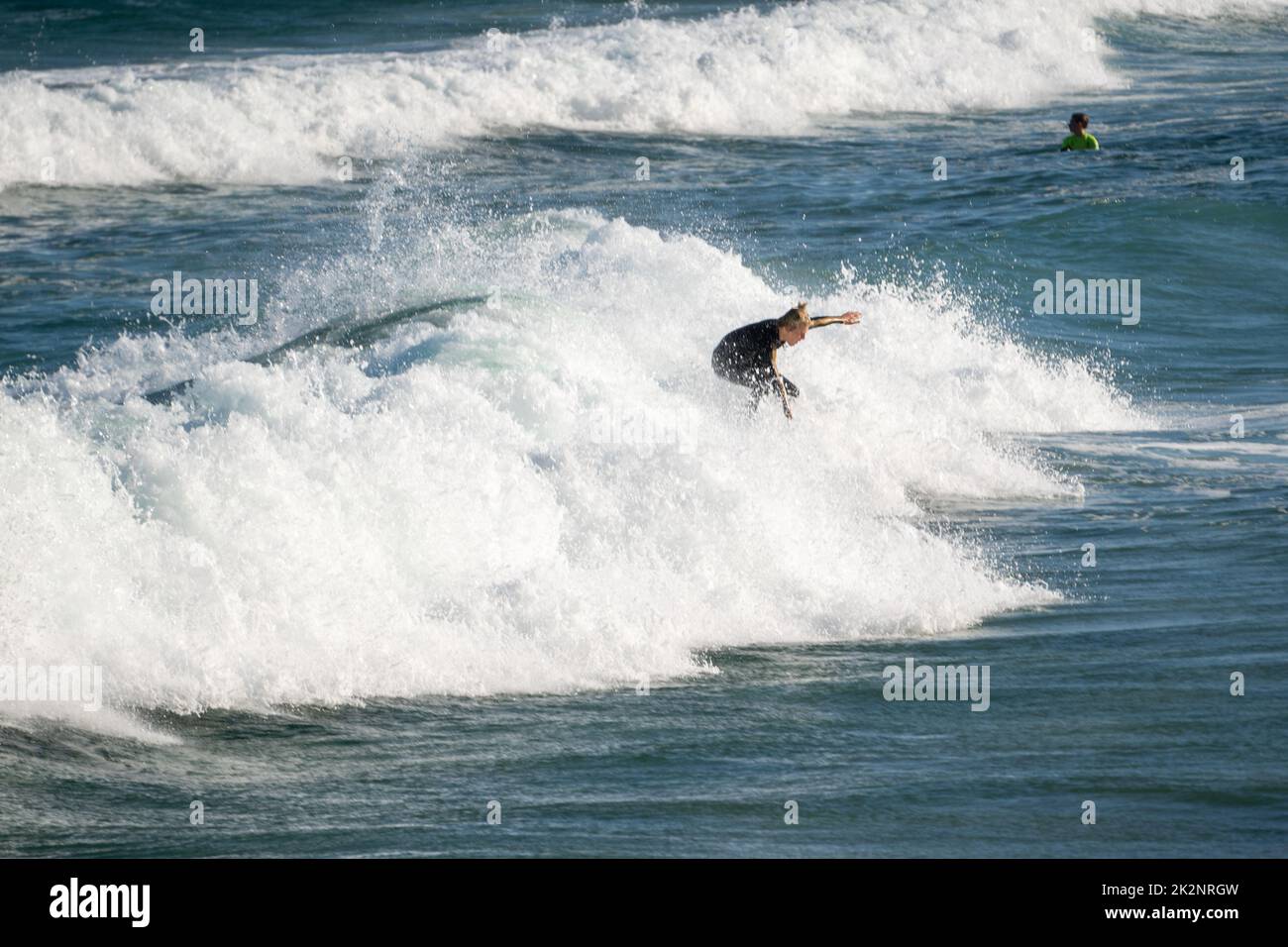 A surfer catching waves on the water near Maroubra Beach Stock Photo