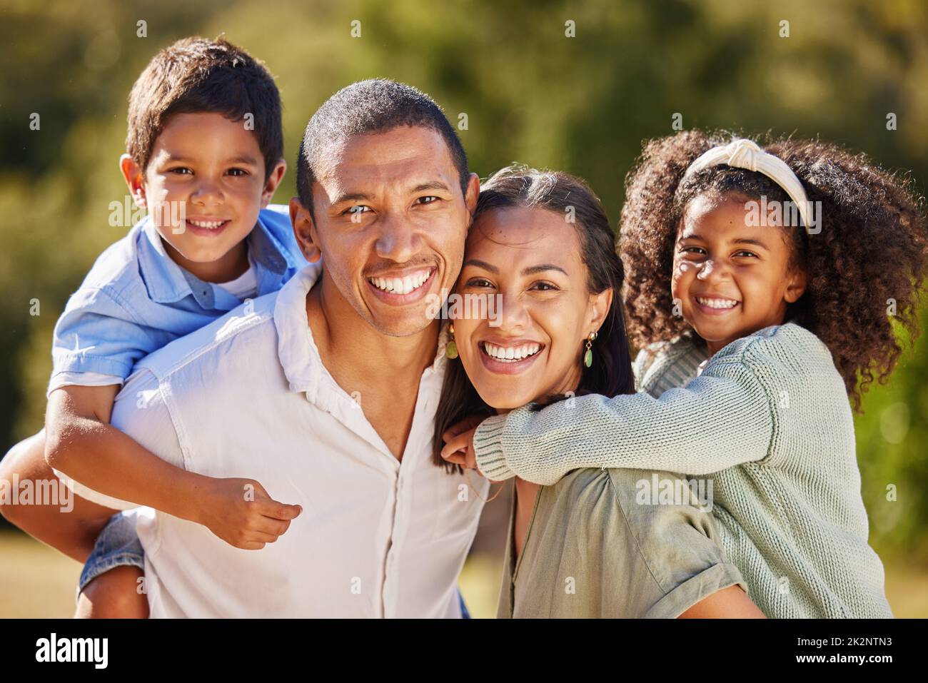 Happy, family and smile of a mom, dad and children in a park in nature ...
