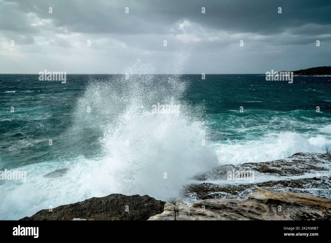 An aerial view of stormy waves splashing against a seashore Stock Photo ...