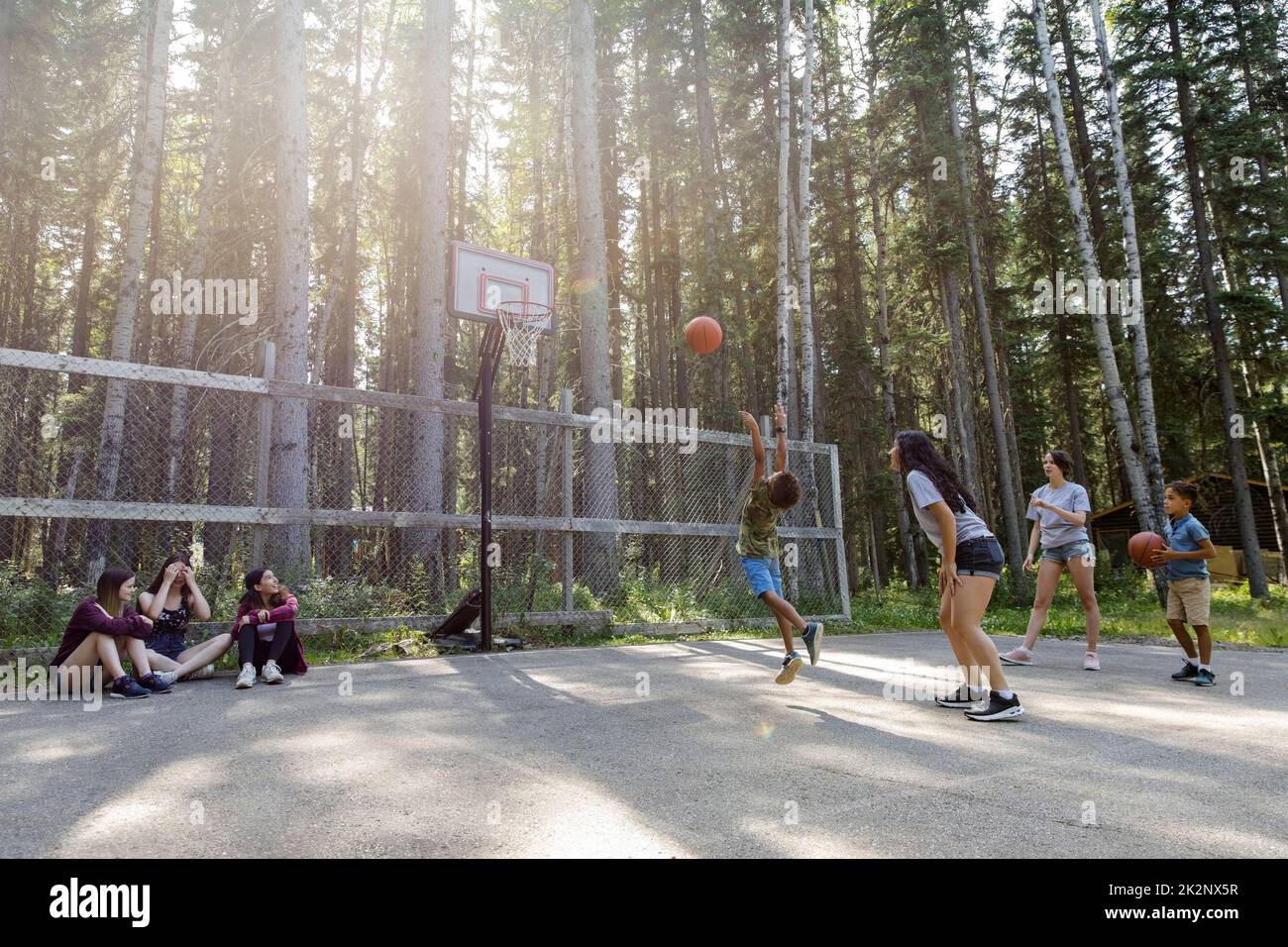 Camp counselors teaching boys basketball at summer camp Stock Photo Alamy