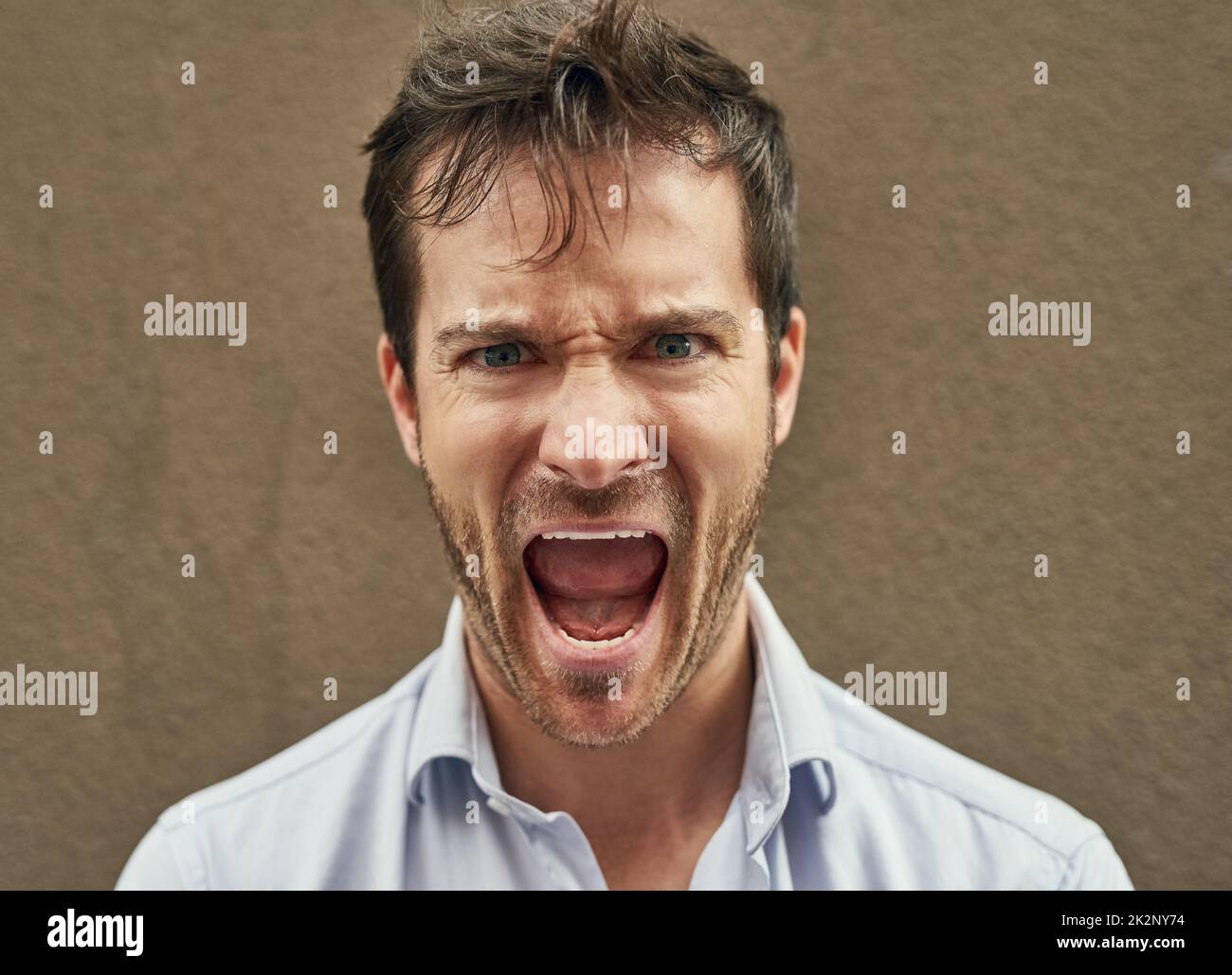 Hes about to bite someones head off. Portrait of an angry young man