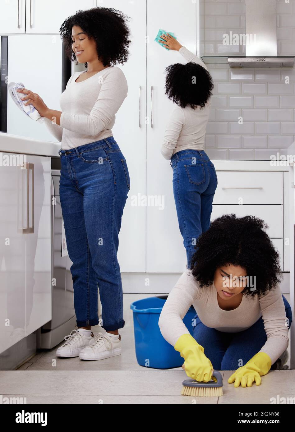 Todays a busy day. Shot of a young woman cleaning the house. Stock Photo