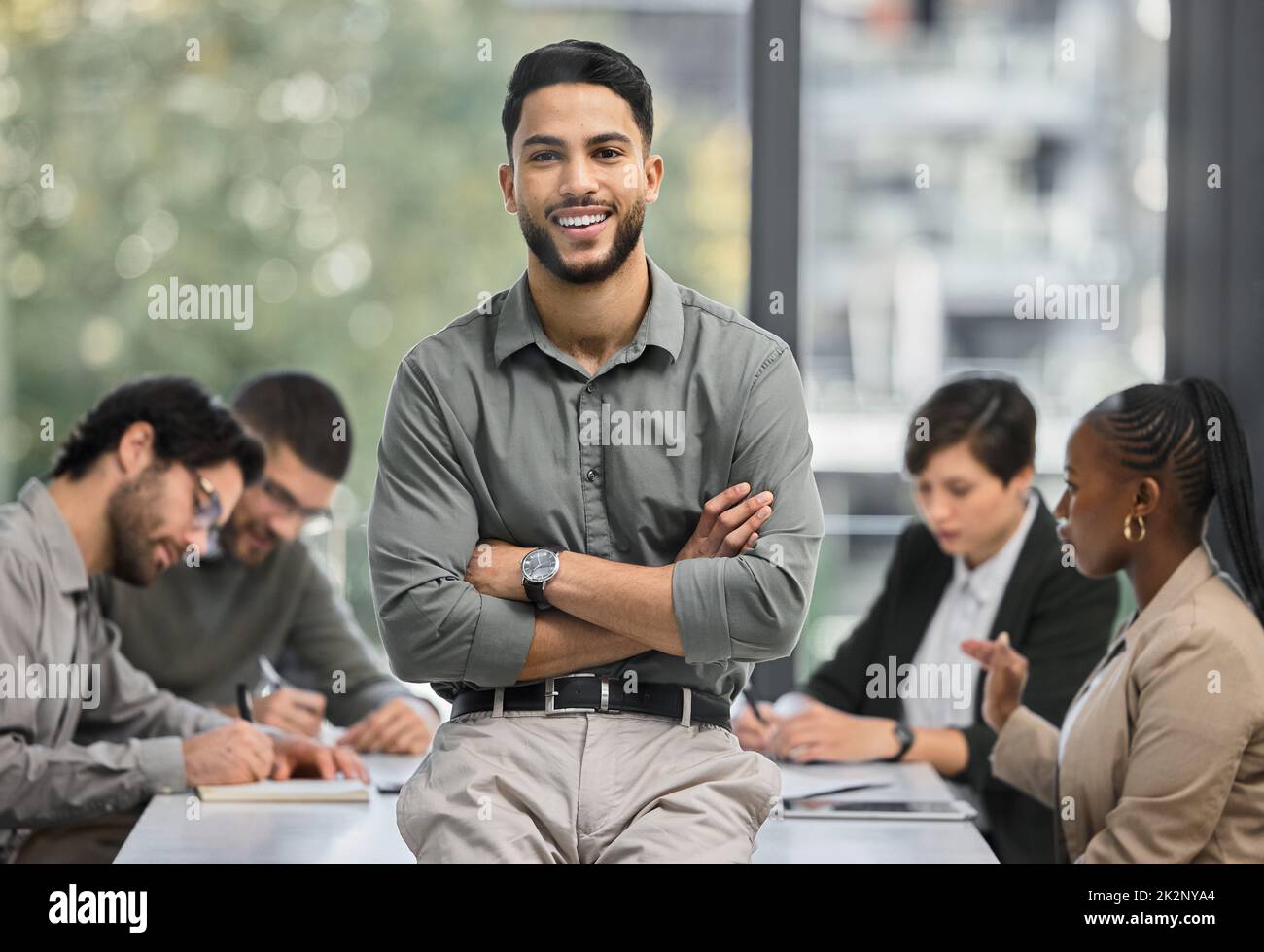 How quickly life can turn around. Portrait of a young businessman at the office sitting in front of his colleagues having a meeting in the background. Stock Photo