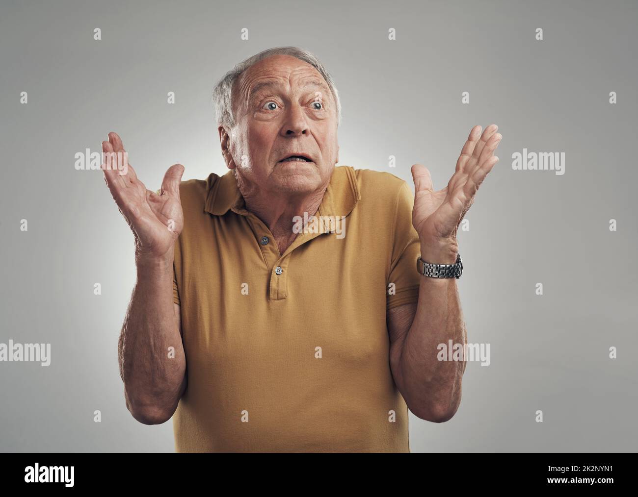 I did not see that coming. Studio of an elderly man in disbelief against a grey background. Stock Photo