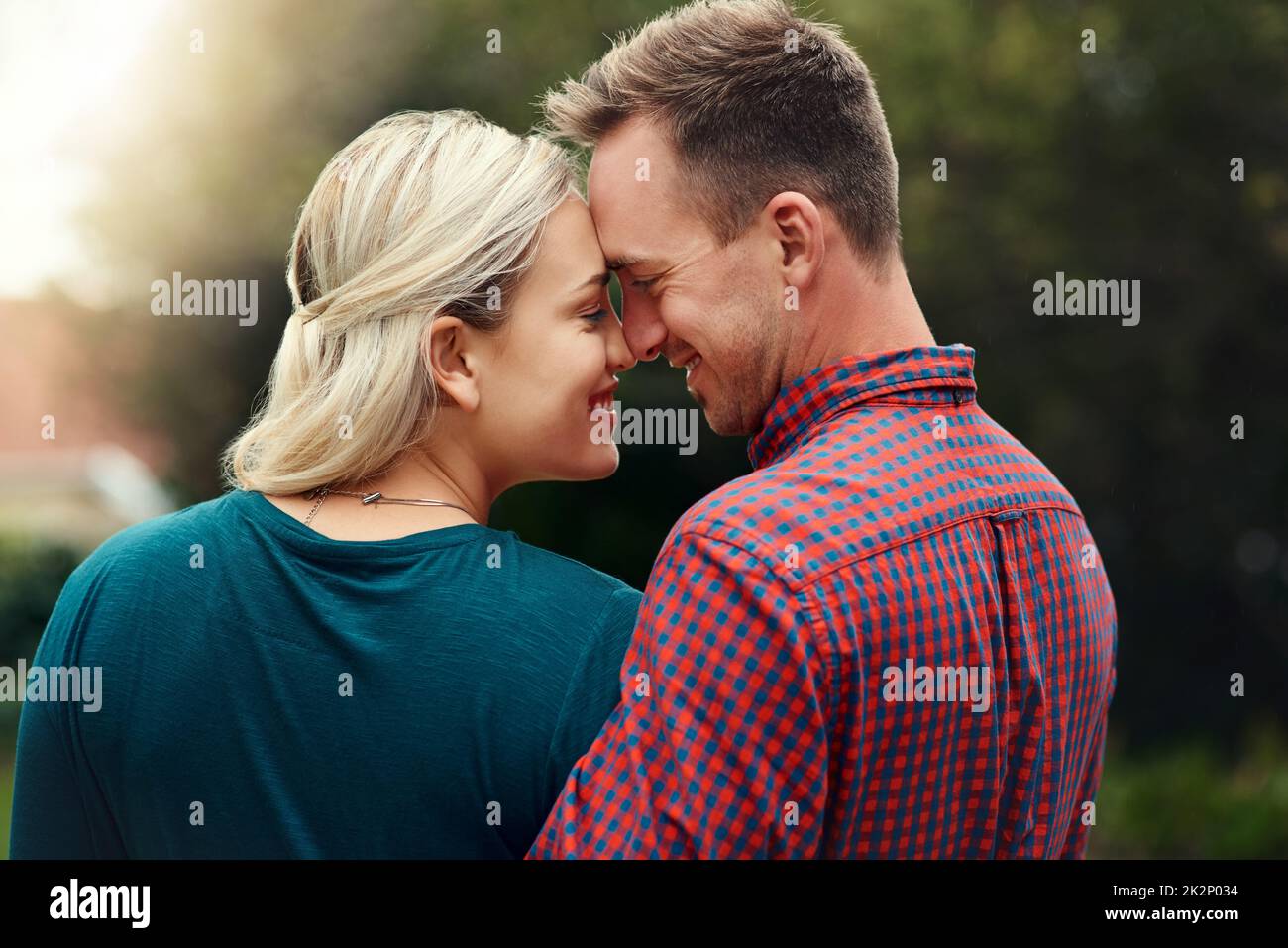 You can tell theyre madly in love. Shot of an affectionate young couple spending quality time together outdoors. Stock Photo