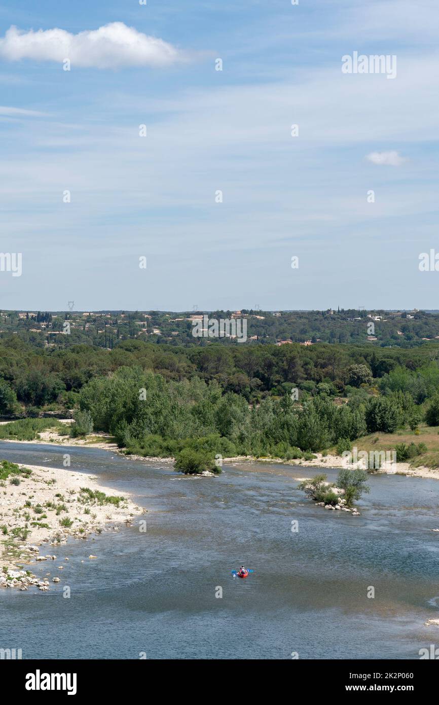 A vertical bird's-eye view of a boat in a river with the background of ...