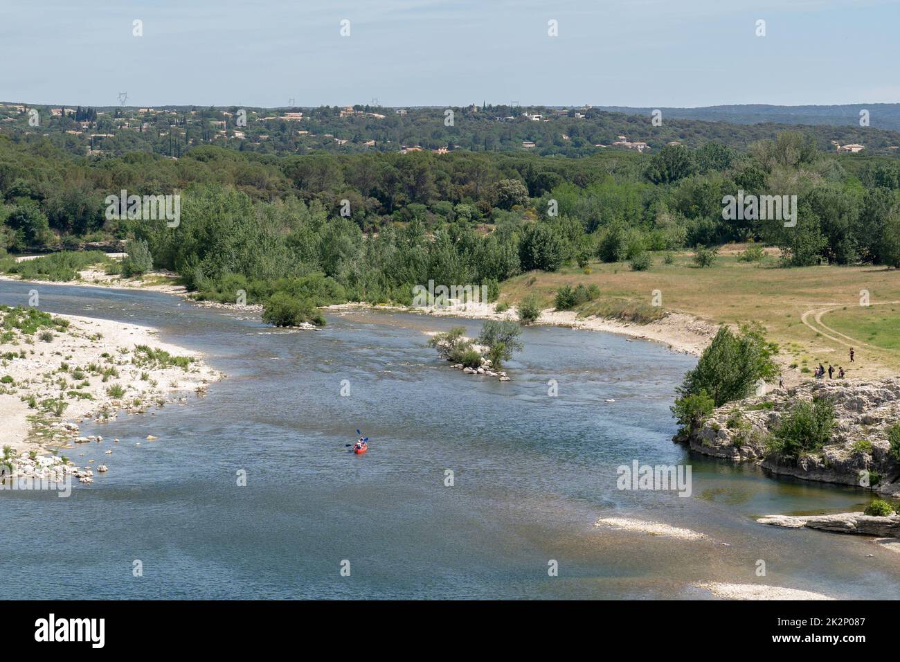 A bird's-eye view of a boat in a river with the background of forests ...