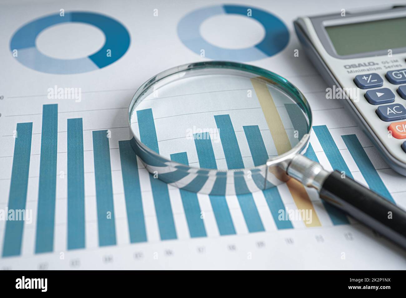 Magnifying glass on charts graphs paper. Financial development, Banking