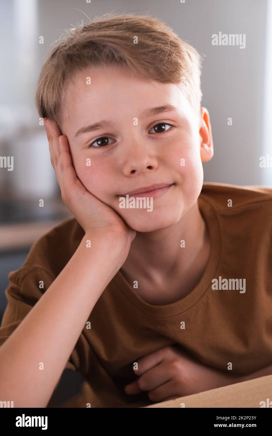 Close up portrait of teenager looking at camera with joyful smiling expression. Blond boy Stock Photo