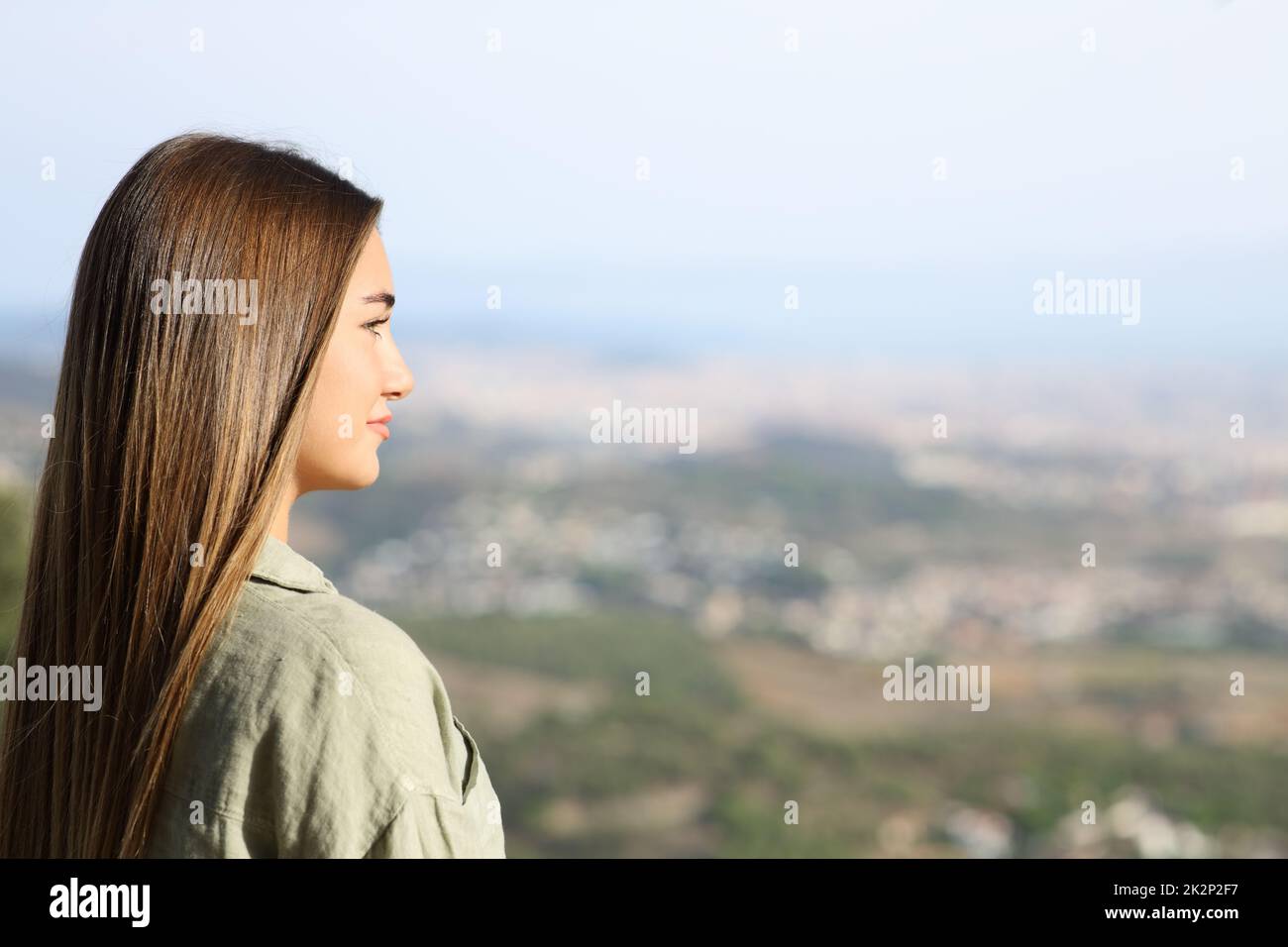 Serious teen contemplating views in city outskirts Stock Photo