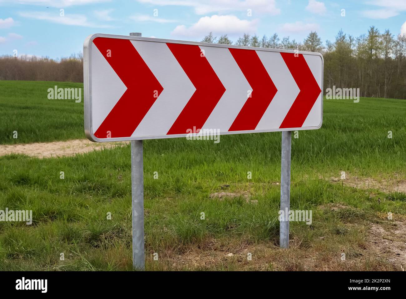 A large warning sign for a very sharp bend on a German country road Stock Photo