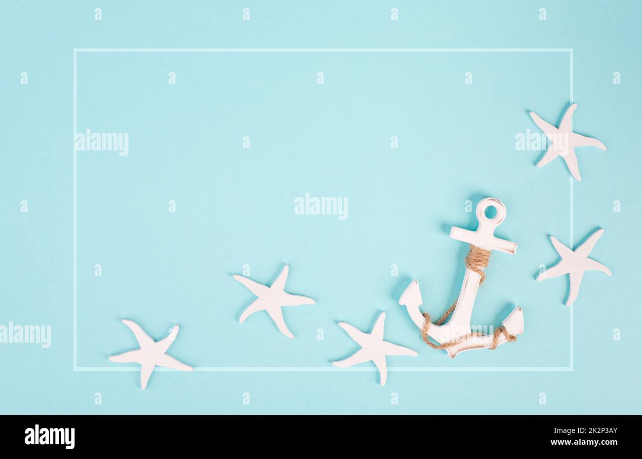 Blue colored summer and vacation background, anchor and sea stars building a frame, copy space for text, holiday and tourism concept Stock Photo