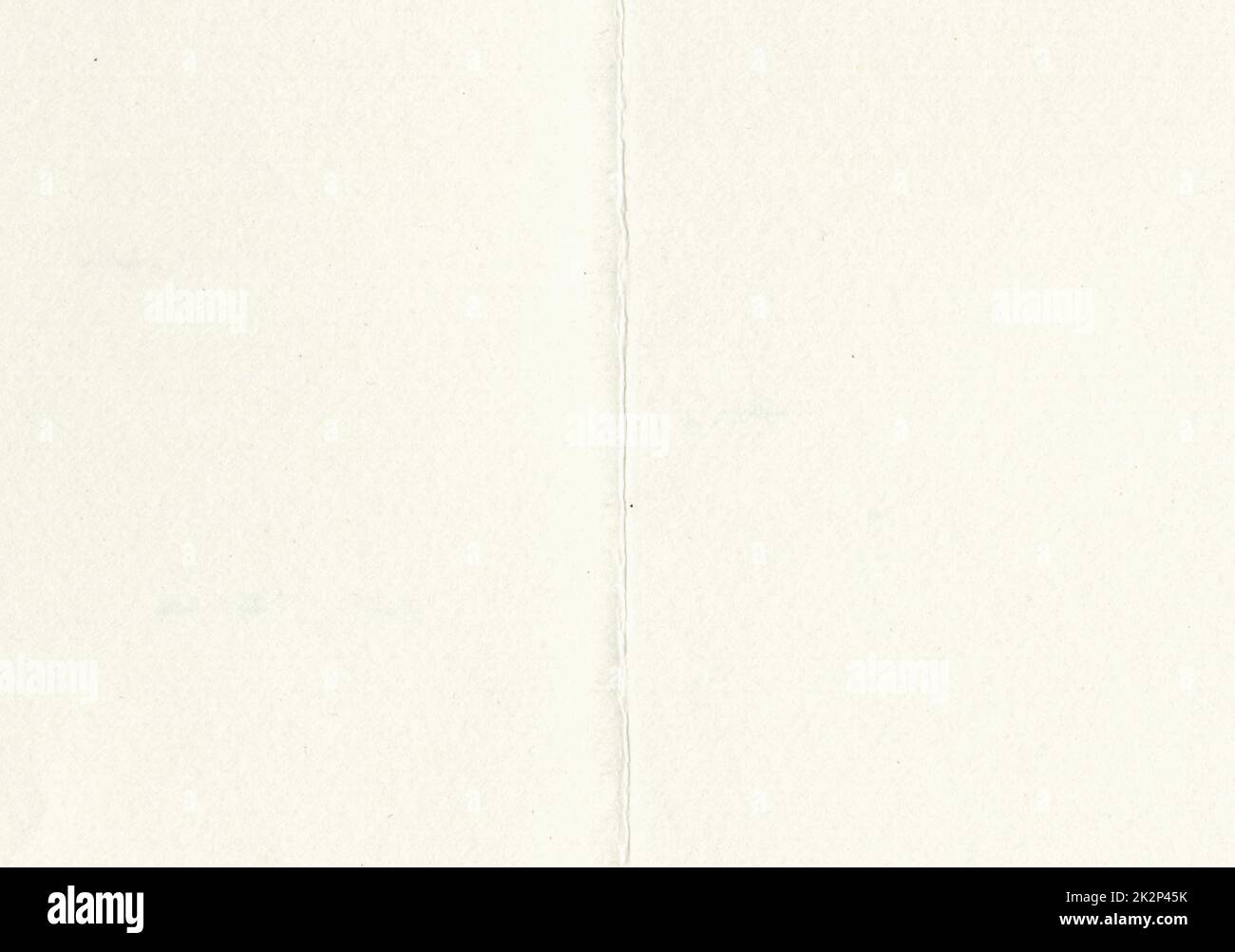 Large image of close up paper texture background folded in half with aged, uncoated fine fiber grain and dust particles in light beige yellowed color smooth with copy space for text wallpaper designs Stock Photo