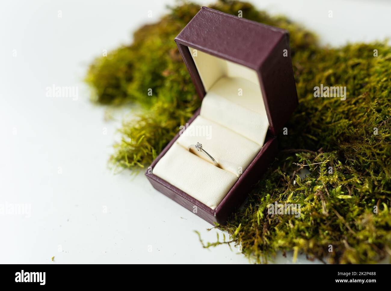 Elegant diamond ring in a box with a beige background. soft and selective focus. Marriage proposal concept. Stock Photo