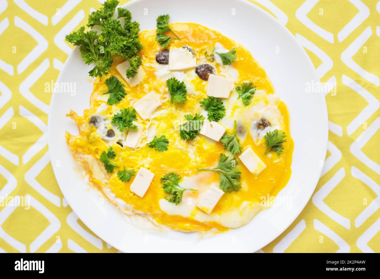 Scrambled eggs with fresh herbs on a plate Stock Photo - Alamy