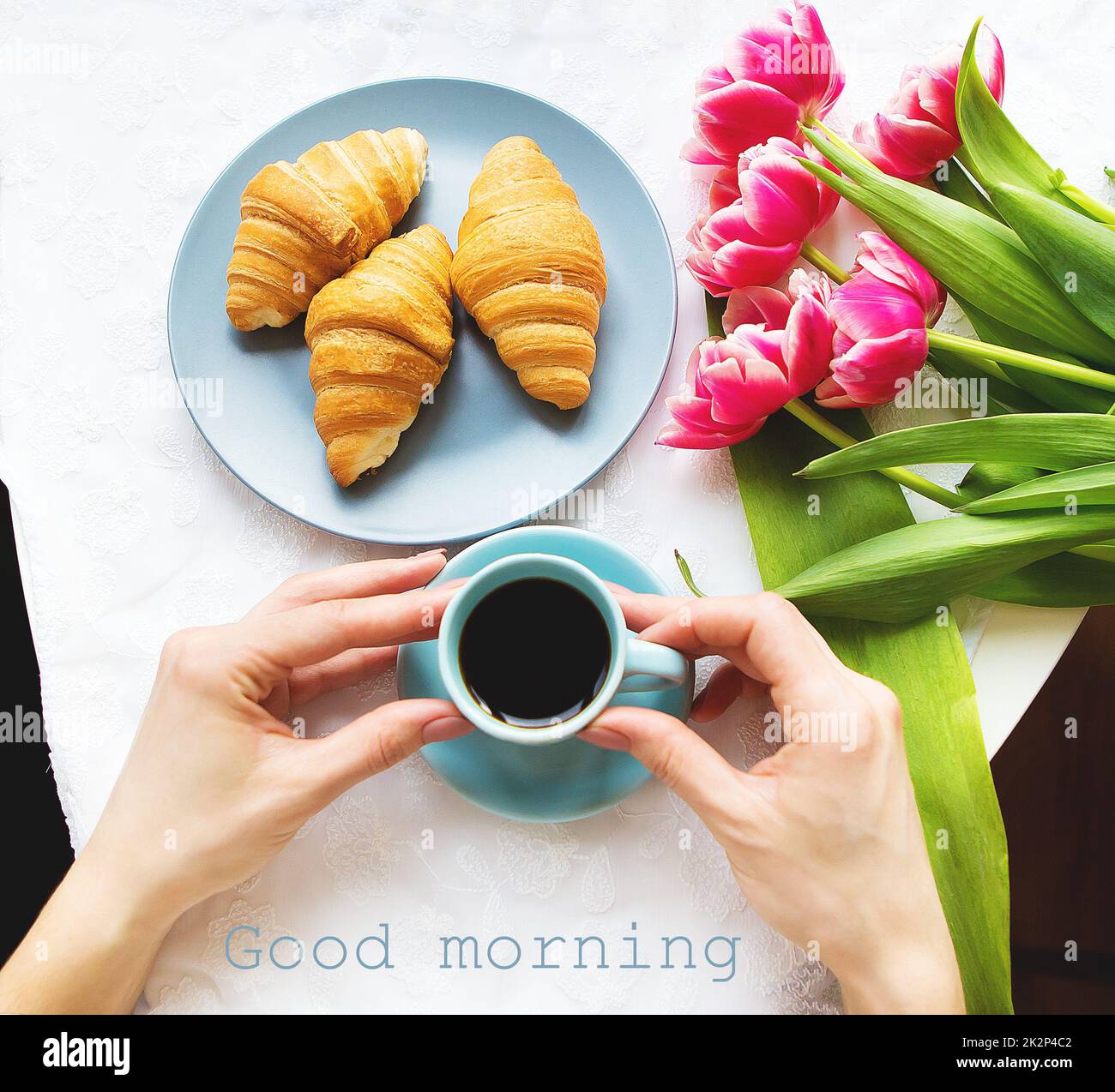Girl with croissants and coffee, a bouquet of pink tulips, happy morning Stock Photo