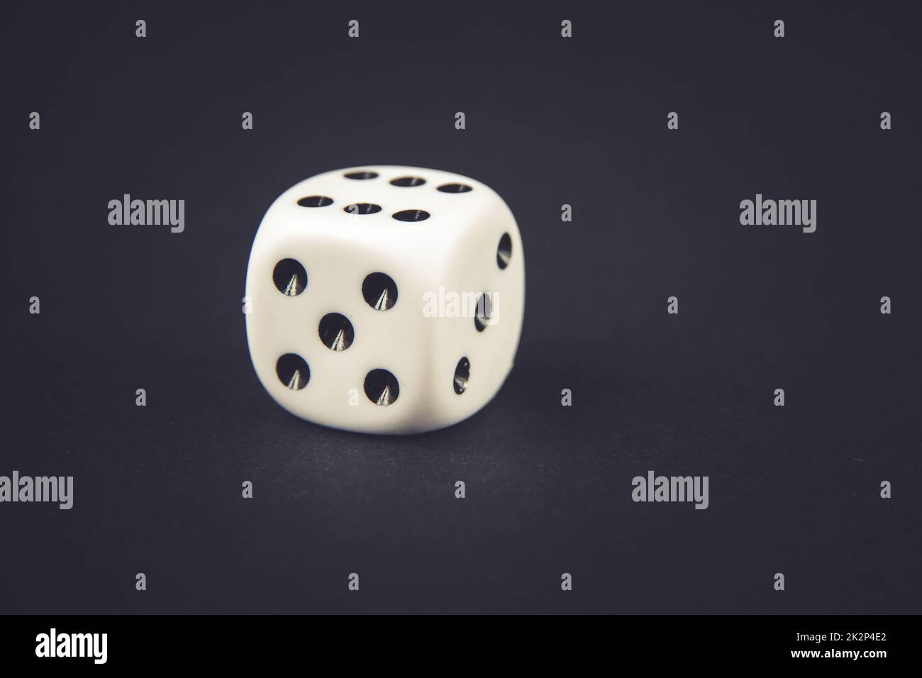 White dice on black table background Stock Photo