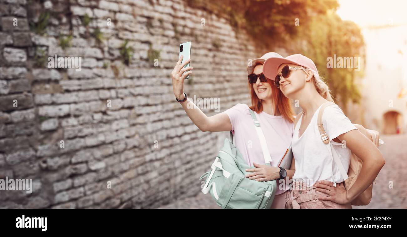 Two woman taking a selfie in old Tallinn, Estonia Stock Photo