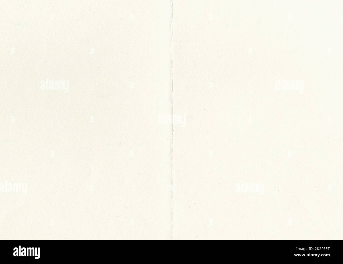 Large image of paper texture background folded in half with aged, uncoated fine fiber grain and dust particles in light beige yellowed color smooth with copy space for text wallpapers or designs Stock Photo