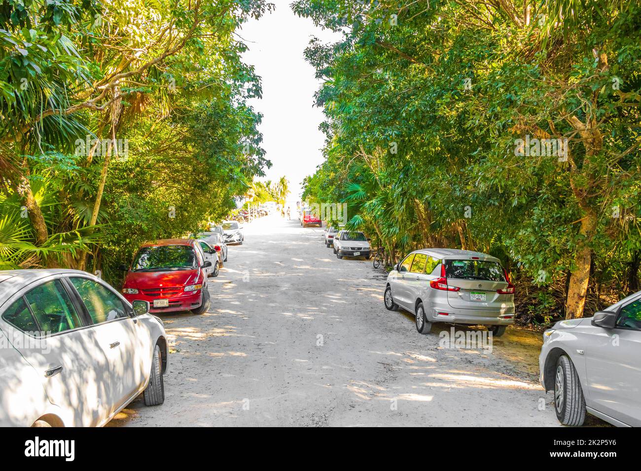 Entrance to caribbean coast beach with parked cars Tulum Mexico. Stock Photo