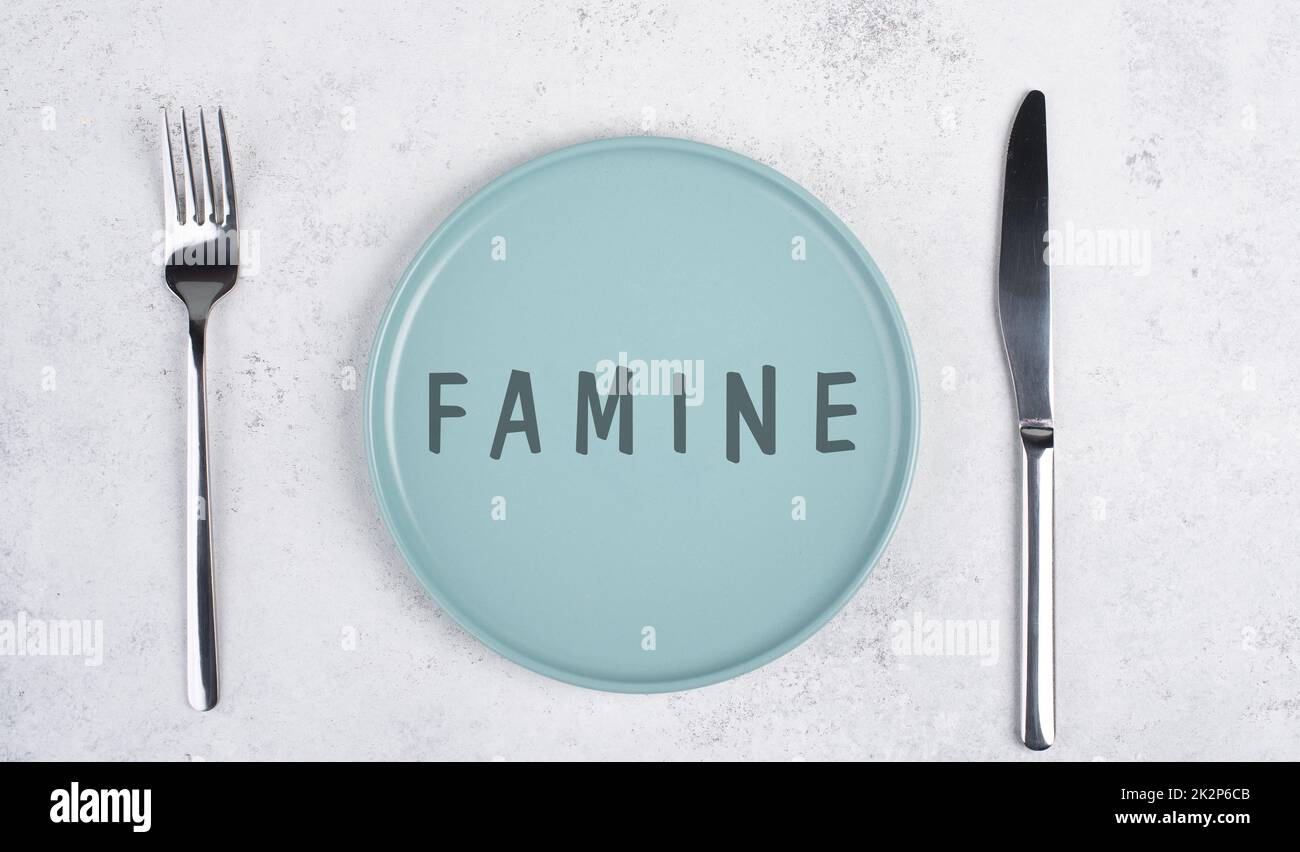Famine is standing on the plate, food shortage and starving because of the war and inflation, political issue Stock Photo