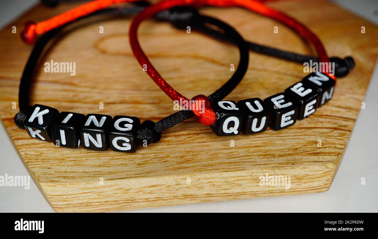 Alphabet initials bracelet with king and queen names Stock Photo
