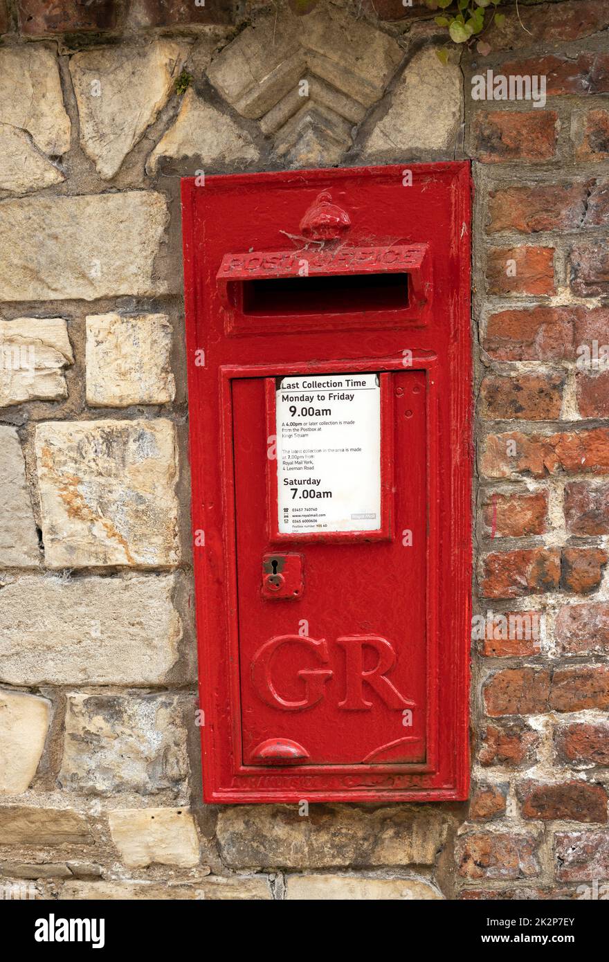 An old wall mounted postbox from the reign of King George, the late Queen's father is still in daily use next to York Minster. Stock Photo