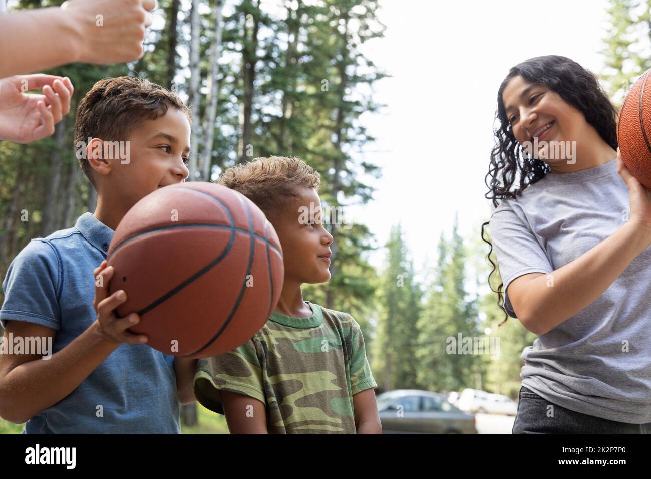 Camp counselor teaching boys basketball at summer camp Stock Photo Alamy