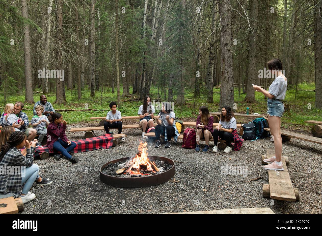 Children sitting around campfire in summer camp Stock Photo Alamy