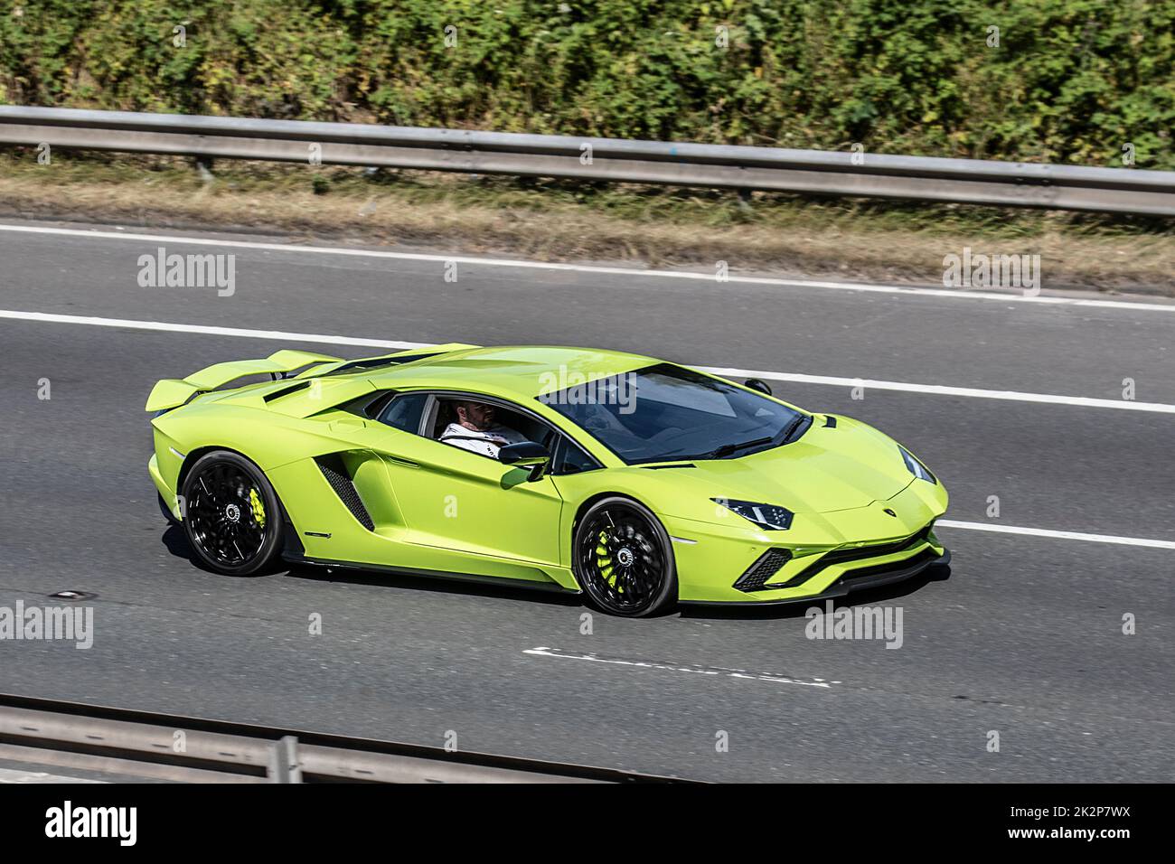 2022 Yellow Lamborghini Aventador Ultimae V12 coupe 12-cylinder mid-engined Italian supercar sports car; Vehicular traffic moving vehicles, 6.5-litre cars driving on UK roads, motors, roadster motoring UK highway network. Stock Photo