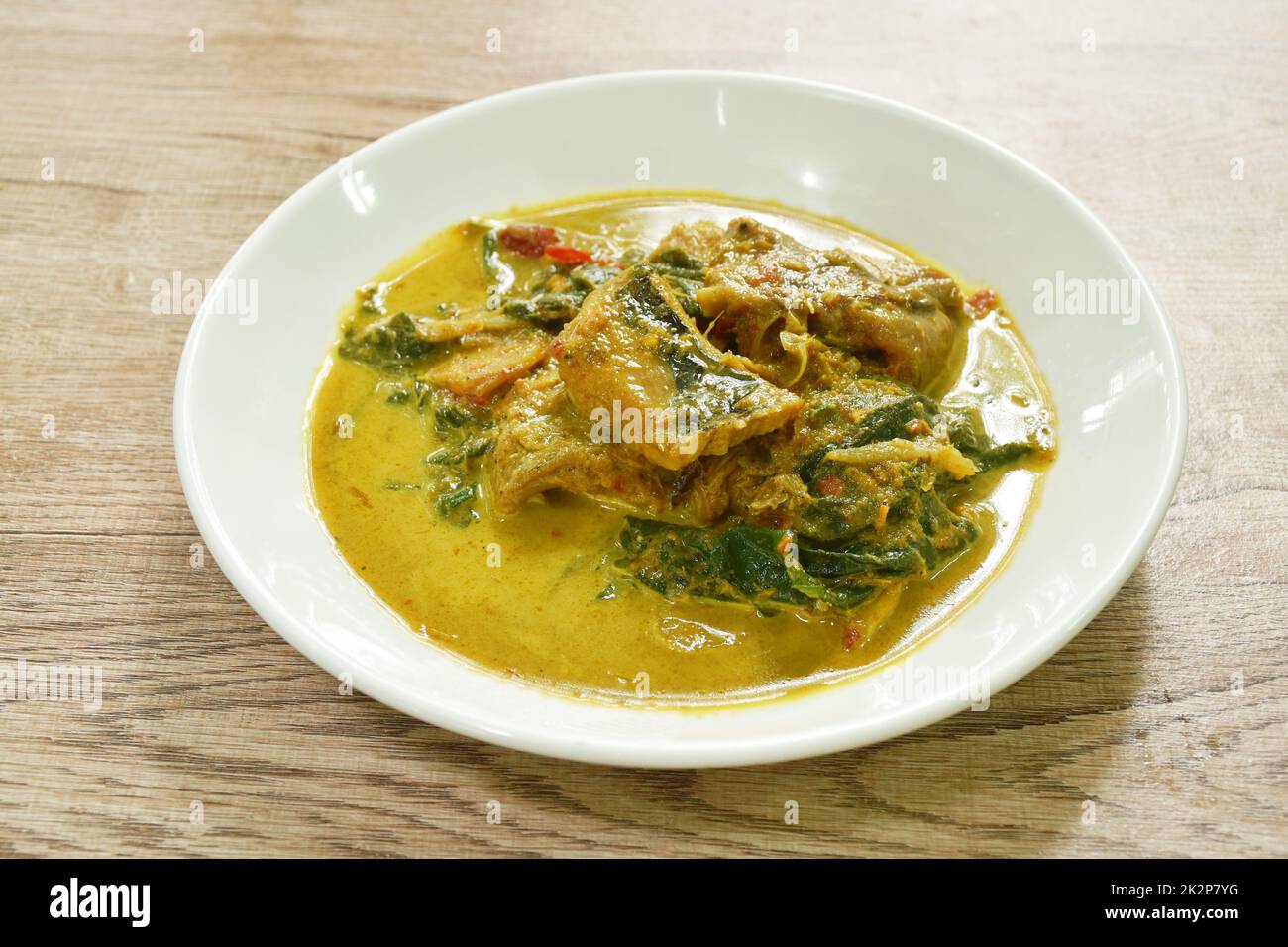 spicy spicy slice stingray fish in coconut milk curry on plate Stock