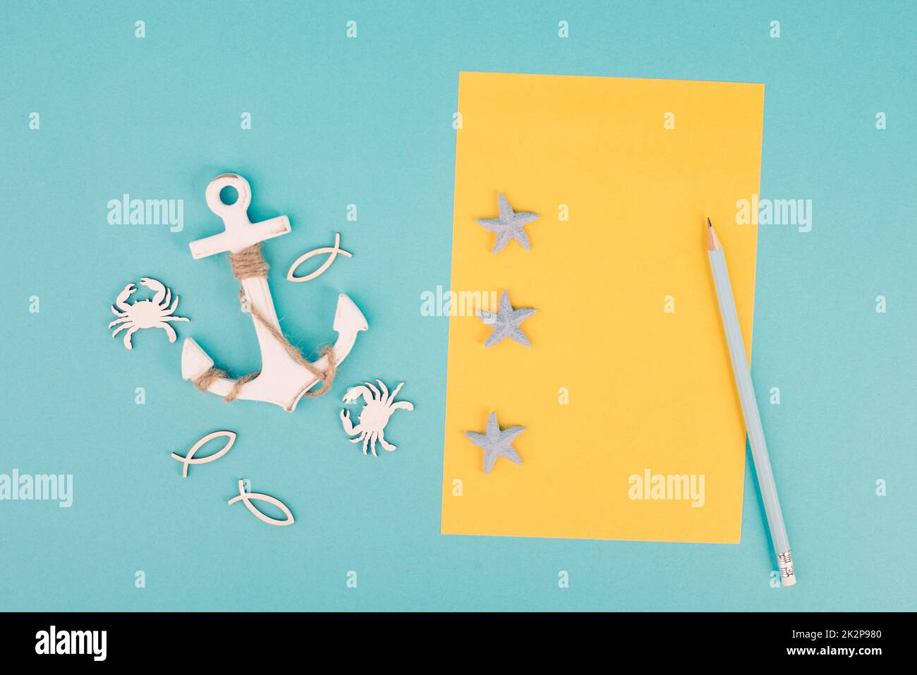 Travel list, yellow colored paper, anchor with fish sea stars and crabs, holiday plan and destination, vacation and lifestyle concept Stock Photo