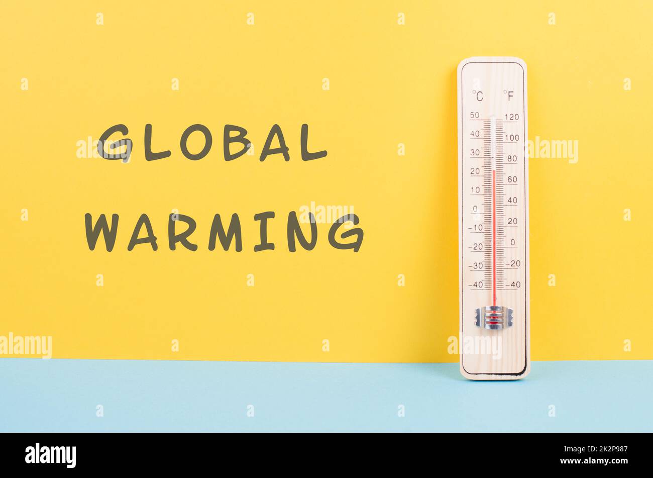 Thermometer on a yellow and blue colored background, measure the temperature, weather forecast, global warming and environment discussion, summer season Stock Photo