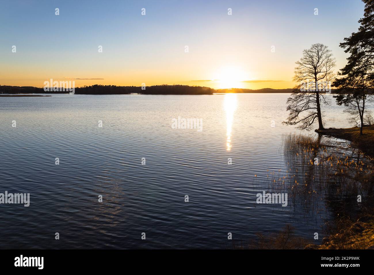 The colorful sky and water in the lake reflected at sunset Stock Photo ...