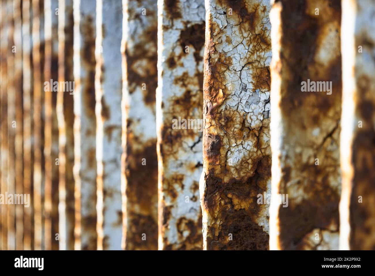 Rusty bridge railing texture background with cracked white paint Stock Photo