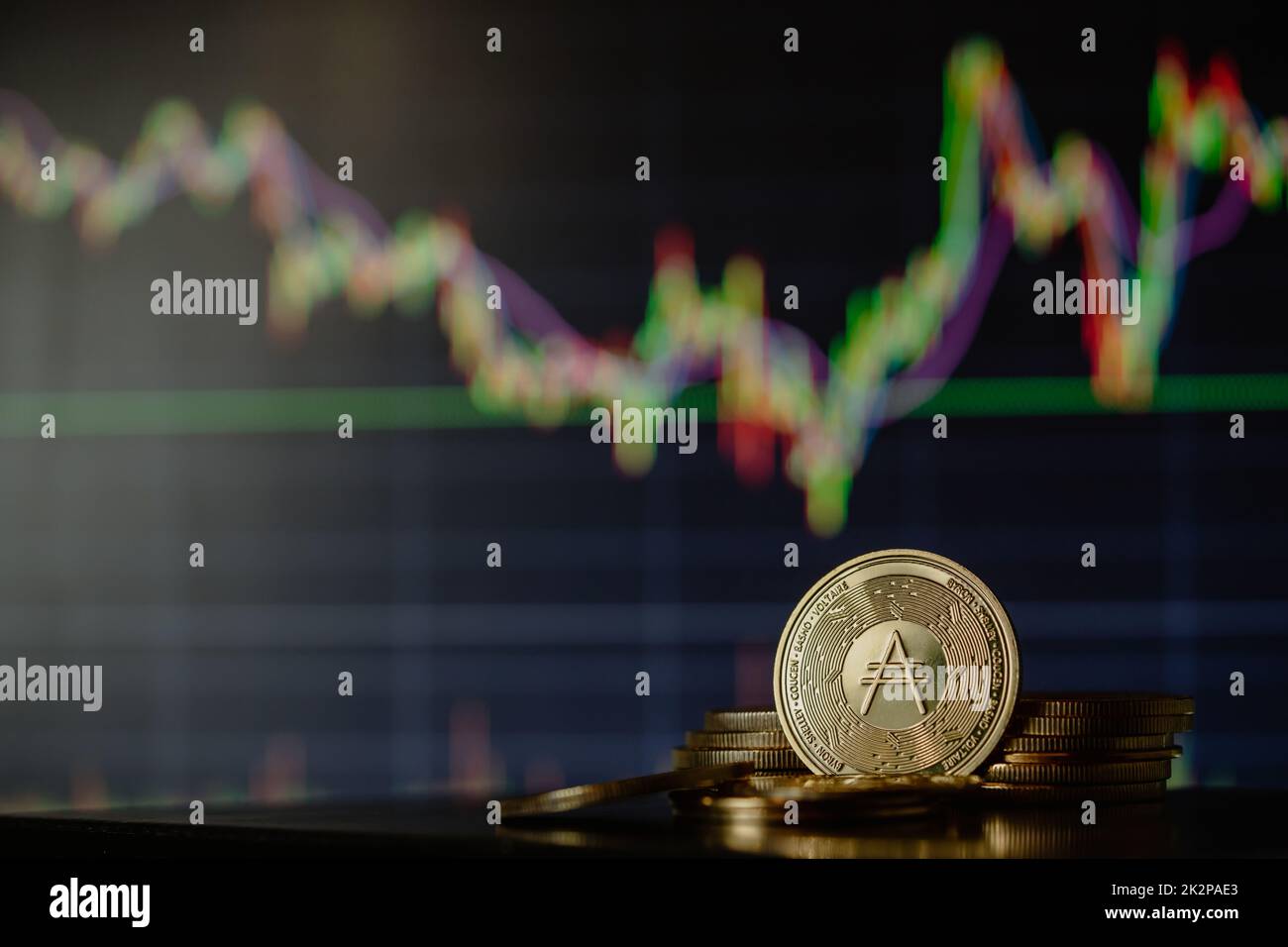 Stack or heap of gold Cardano ADA cryptocurrency with candle stick graph chart and digital background. Stock Photo