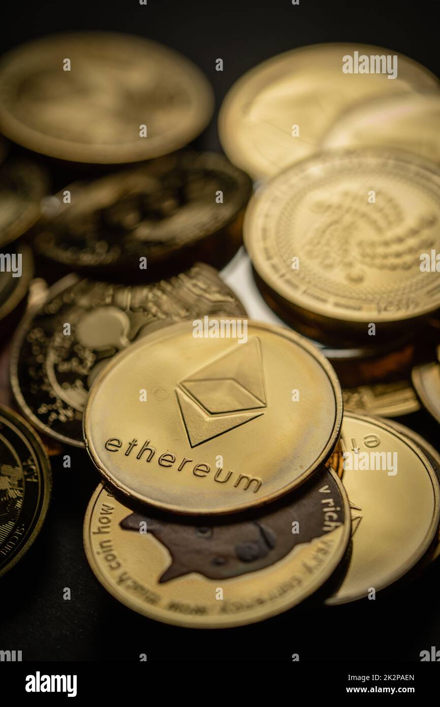 Close up shot of a golden Ethereum in a stack of coins, among other various digital cryptocurrencies. Stock Photo