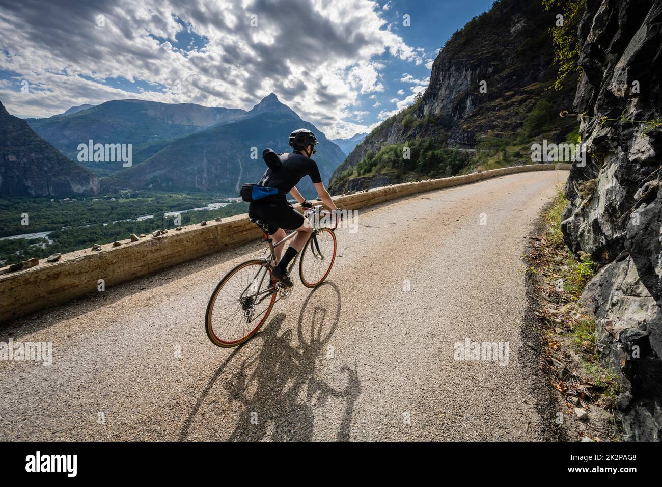 Male road cyclist riding up the balcony road to Villard Notre Dame from Bourg d'Oisans, French Alps. Stock Photo