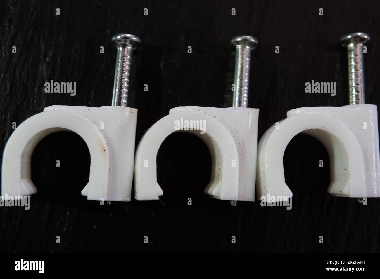plastic nail cable clamp on the wall Stock Photo Alamy