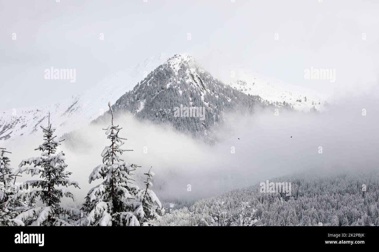 Winter mountain landscape and cloudy sky in Davos, Switzerland Stock Photo